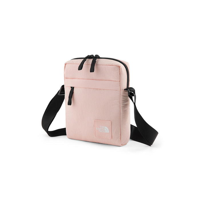 THE NORTH FACE® TNF CITY VOYAGER CROSS BODY EVENING SAND PINK/TNF BLACK